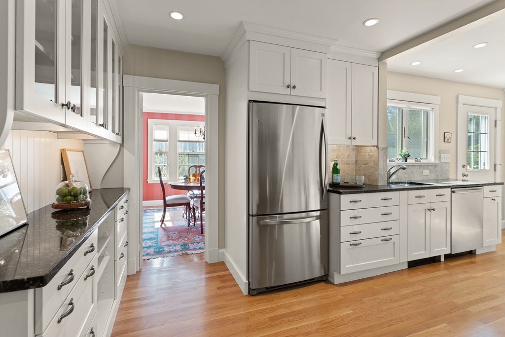 29 Kenwin Road Winchester, MA 01890 - Photo 15 of 35 a kitchen with white cabinets stainless steel appliances and wooden floor