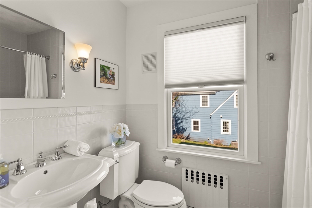 29 Kenwin Road Winchester, MA 01890 - Photo 24 of 35 a bathroom with a toilet sink and mirror