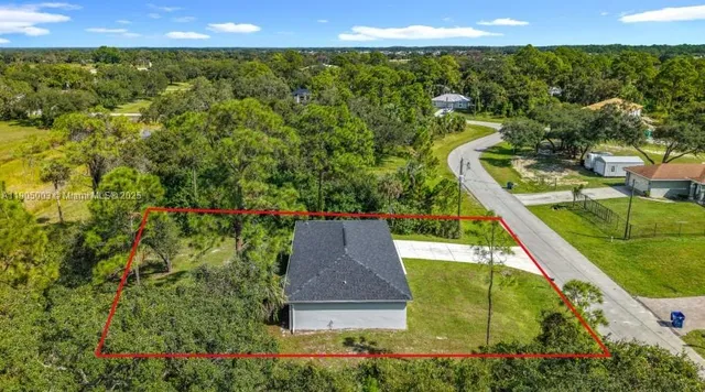 a view of a city with lush green forest