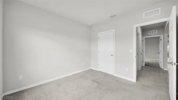 a view of an empty room and a window