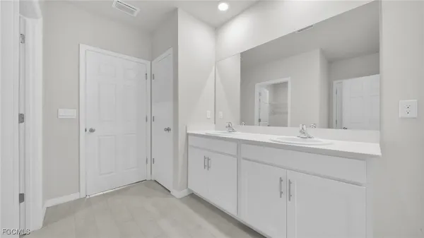 a bathroom with 2 sink and a mirror