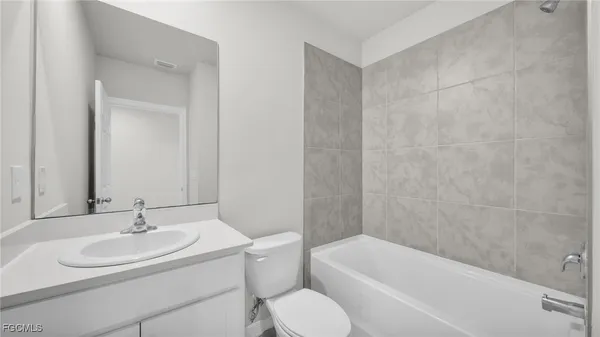 a bathroom with a sink toilet and bathtub