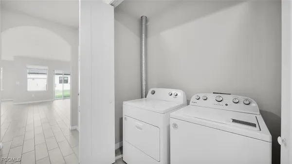 a view of storage and utility room with washer and dryer