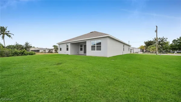 a front view of house with a garden