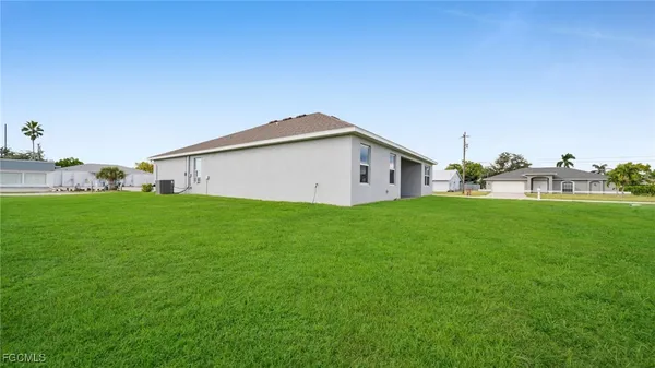 a view of house with backyard
