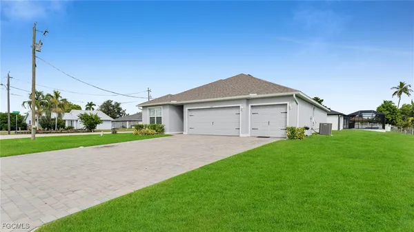 a front view of house with yard and green space