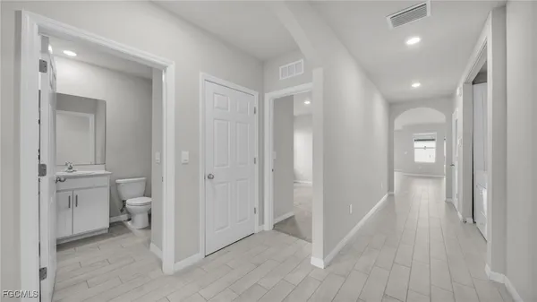 a view of a hallway with wooden floor
