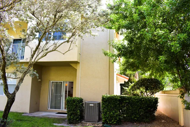a front view of a house with a yard garage and outdoor seating