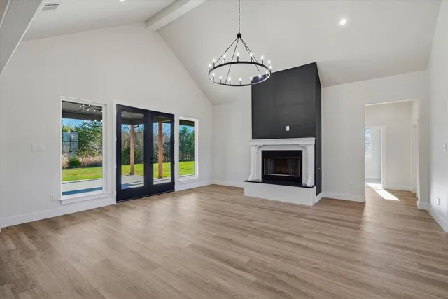 a view of an empty room with glass door and balcony