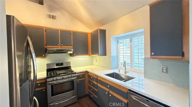 a view of a kitchen with wooden floor and a window