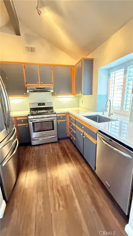 a view of a kitchen with a sink and a window