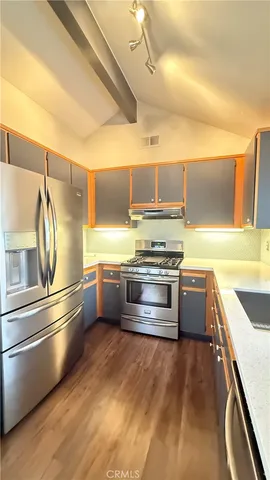 an empty room with windows and fireplace