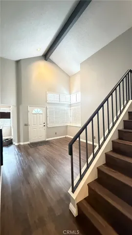 a kitchen with stainless steel appliances a stove a microwave a sink and white cabinets