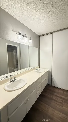 a view of a room that has wooden floor and a window