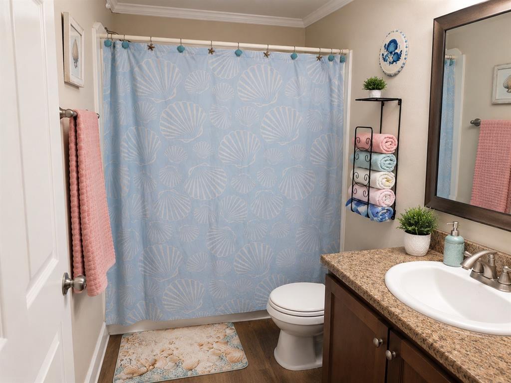 2900 Interstate 35, Unit 80 Waco, TX 76706 - Photo 8 of 10 a bathroom with a granite countertop sink toilet and shower