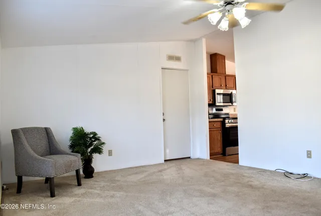 a kitchen with stainless steel appliances granite countertop a refrigerator a sink a stove and a refrigerator