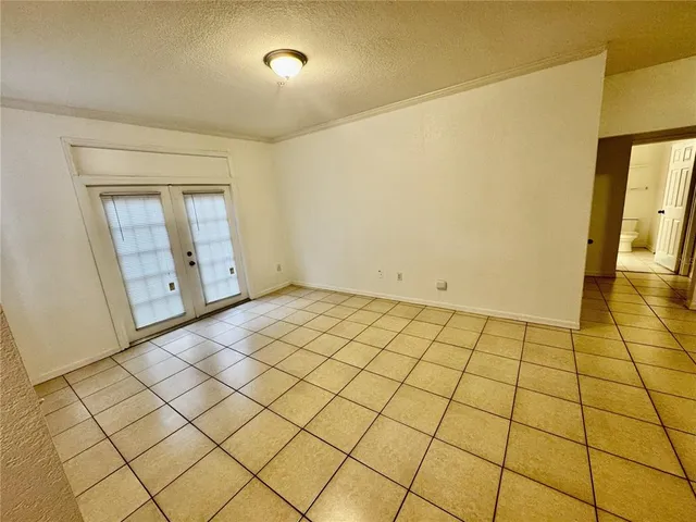 a view of an empty room and wooden floor