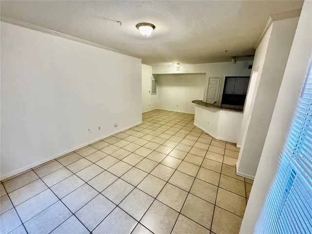 a view of an empty room and wooden floor