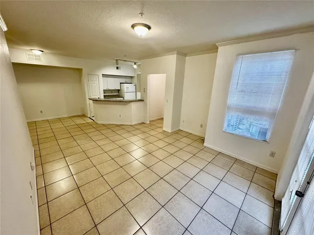 a view of a kitchen with wooden floor and cabinets