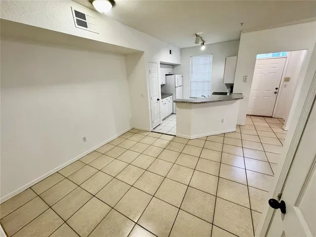 a view of a kitchen with white cabinets
