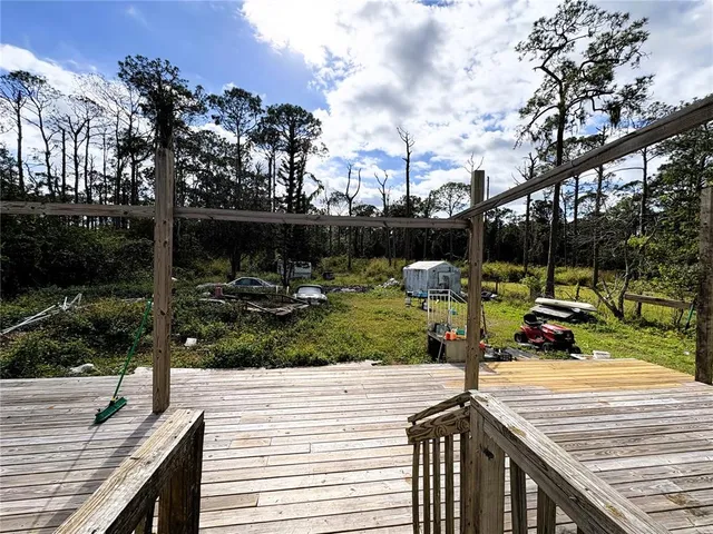 a view of a wooden deck with chairs