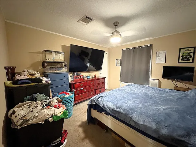 a bedroom with bed and flat screen tv