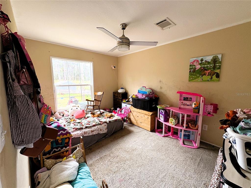 5138 Countryside Court St. Cloud, FL 34771 - Photo 7 of 18 a bedroom with furniture toys and a window