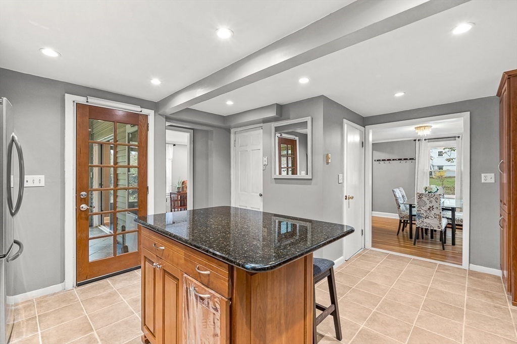 6 Marchant Road Winchester, MA 01890 - Photo 14 of 42 a kitchen island with a table and chairs