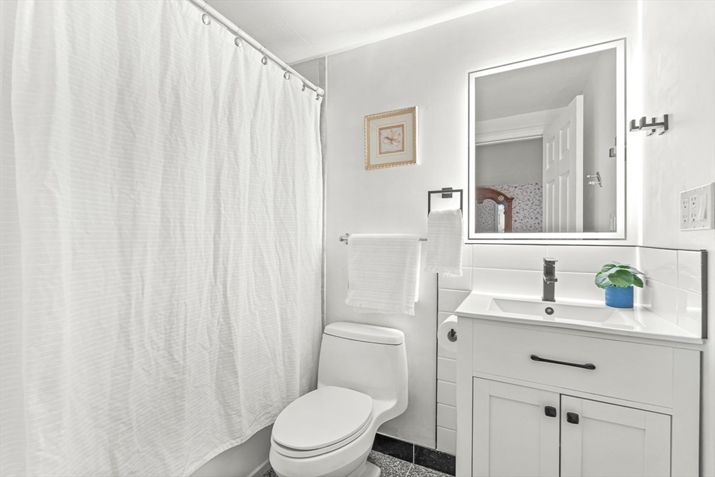 6 Marchant Road Winchester, MA 01890 - Photo 27 of 42 a bathroom with a sink a toilet and shower curtain