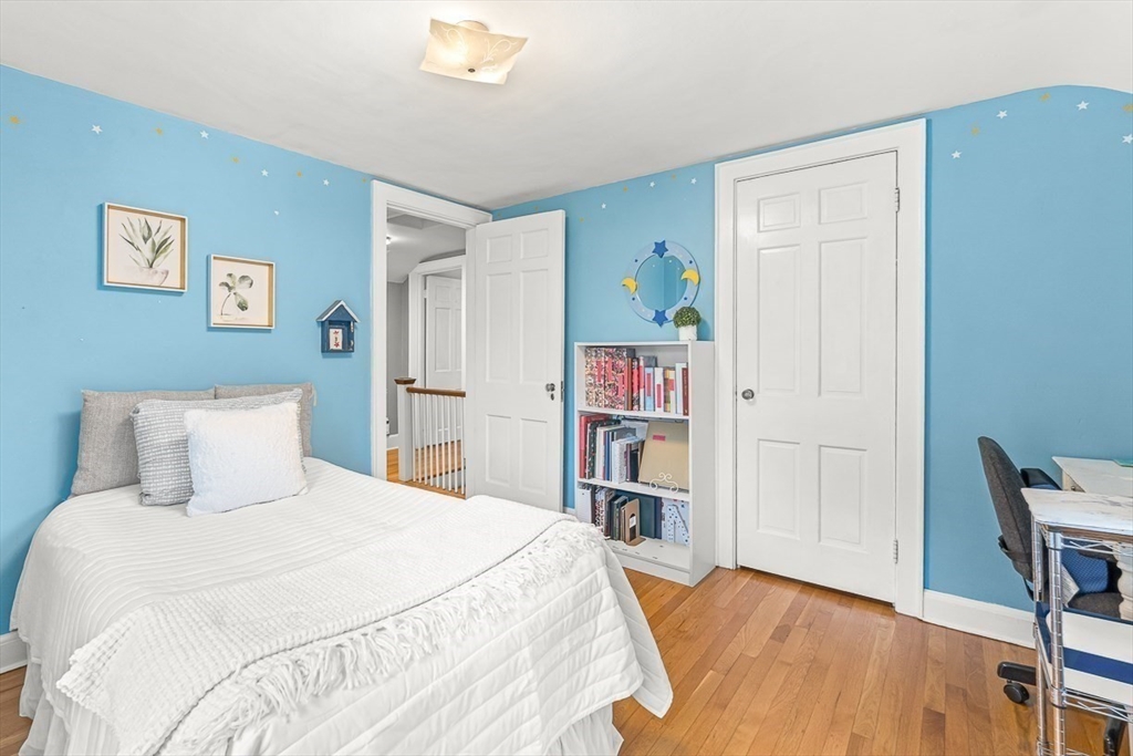 6 Marchant Road Winchester, MA 01890 - Photo 33 of 42 a bedroom with a bed and a bookshelf