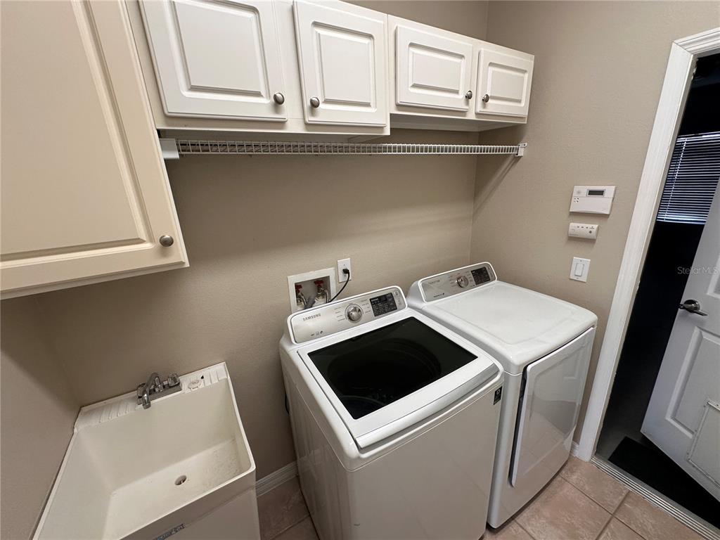 4962 Rock Rose Loop Sanford, FL 32771 - Photo 13 of 27 a utility room with dryer and washer