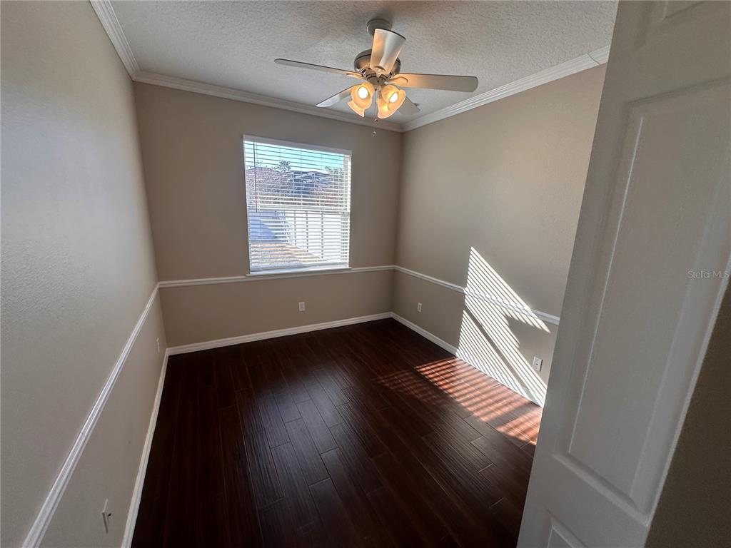 4962 Rock Rose Loop Sanford, FL 32771 - Photo 16 of 27 a view of an empty room with wooden floor and a window