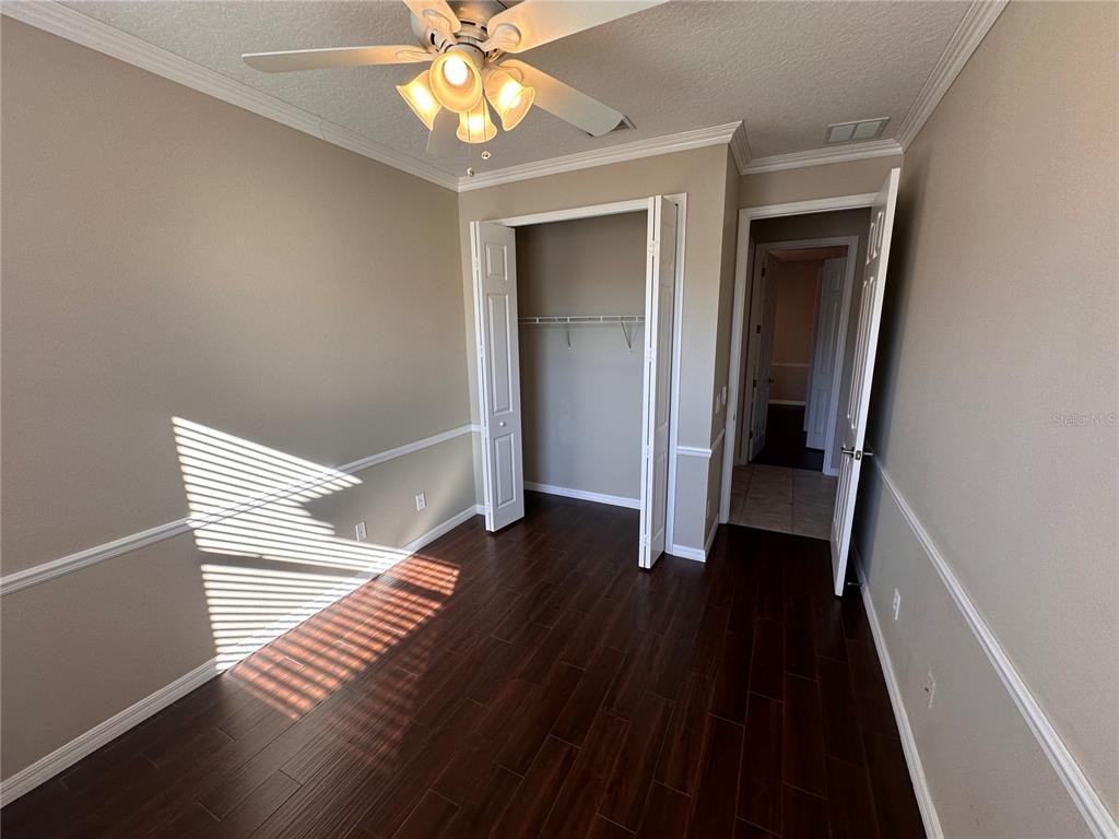 4962 Rock Rose Loop Sanford, FL 32771 - Photo 17 of 27 a view of a hallway with wooden floor