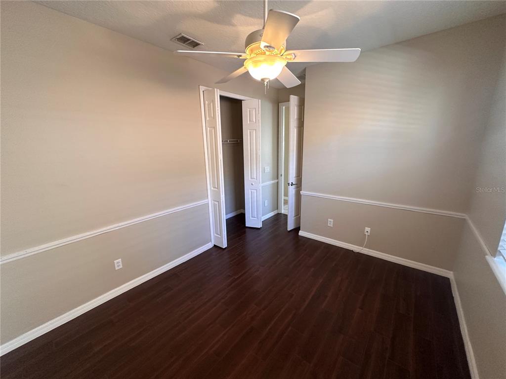 4962 Rock Rose Loop Sanford, FL 32771 - Photo 20 of 27 wooden floor in an empty room with a window