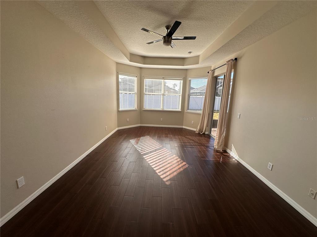4962 Rock Rose Loop Sanford, FL 32771 - Photo 25 of 27 a view of empty room with wooden floor and fan