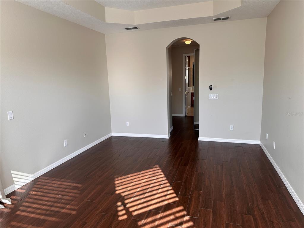 4962 Rock Rose Loop Sanford, FL 32771 - Photo 26 of 27 a view of front door with wooden floor