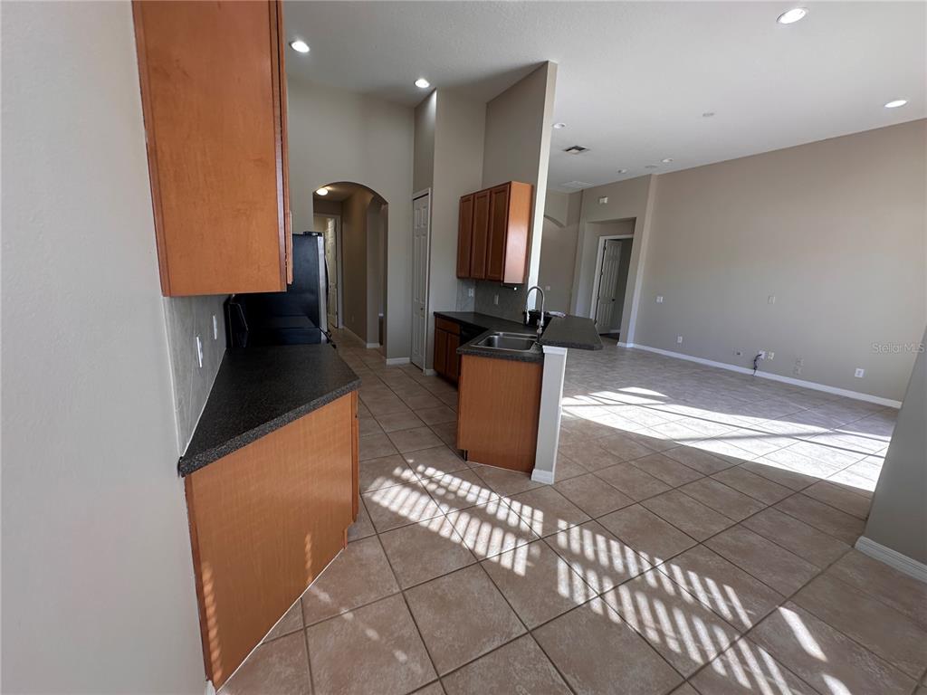 4962 Rock Rose Loop Sanford, FL 32771 - Photo 6 of 27 a kitchen with stainless steel appliances a refrigerator and a counter top space