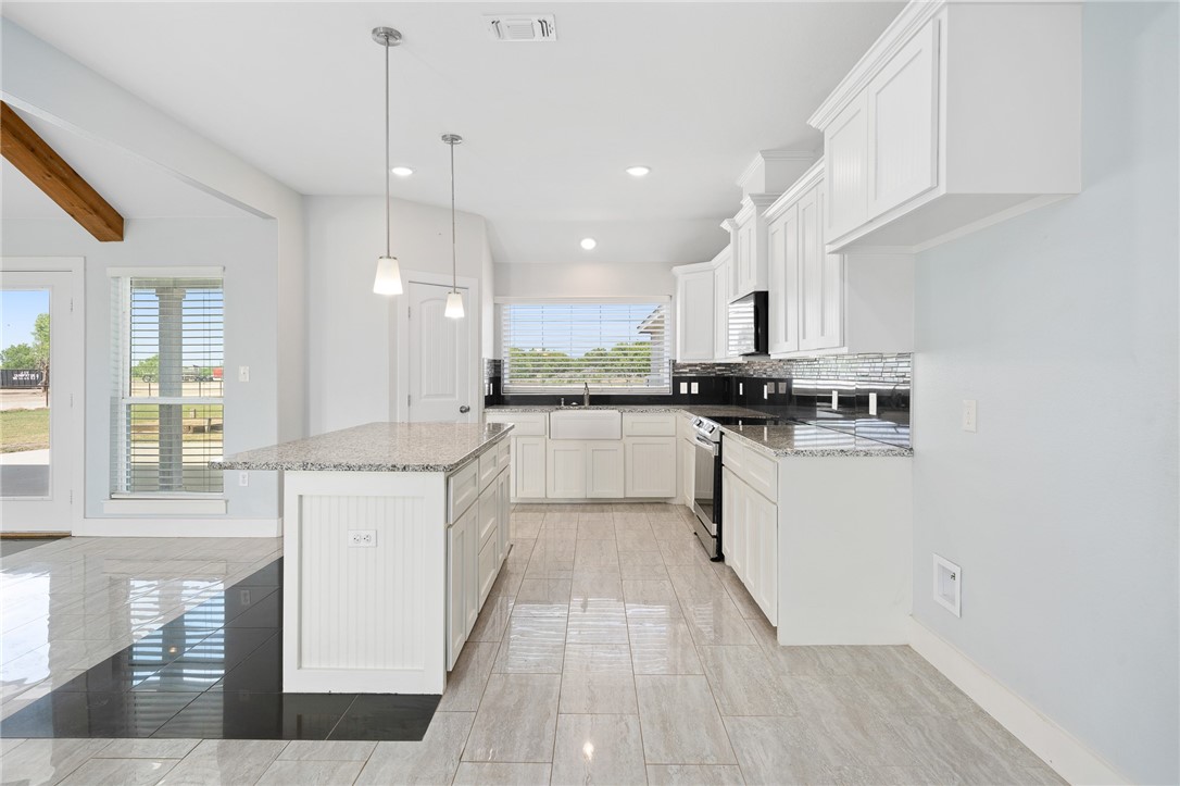 4331 Callicoatte Road Robstown, TX 78380 - Photo 11 of 40 a kitchen with stainless steel appliances granite countertop a stove a sink and a refrigerator