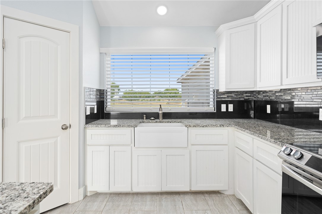 4331 Callicoatte Road Robstown, TX 78380 - Photo 12 of 40 a kitchen with granite countertop white cabinets and white appliances
