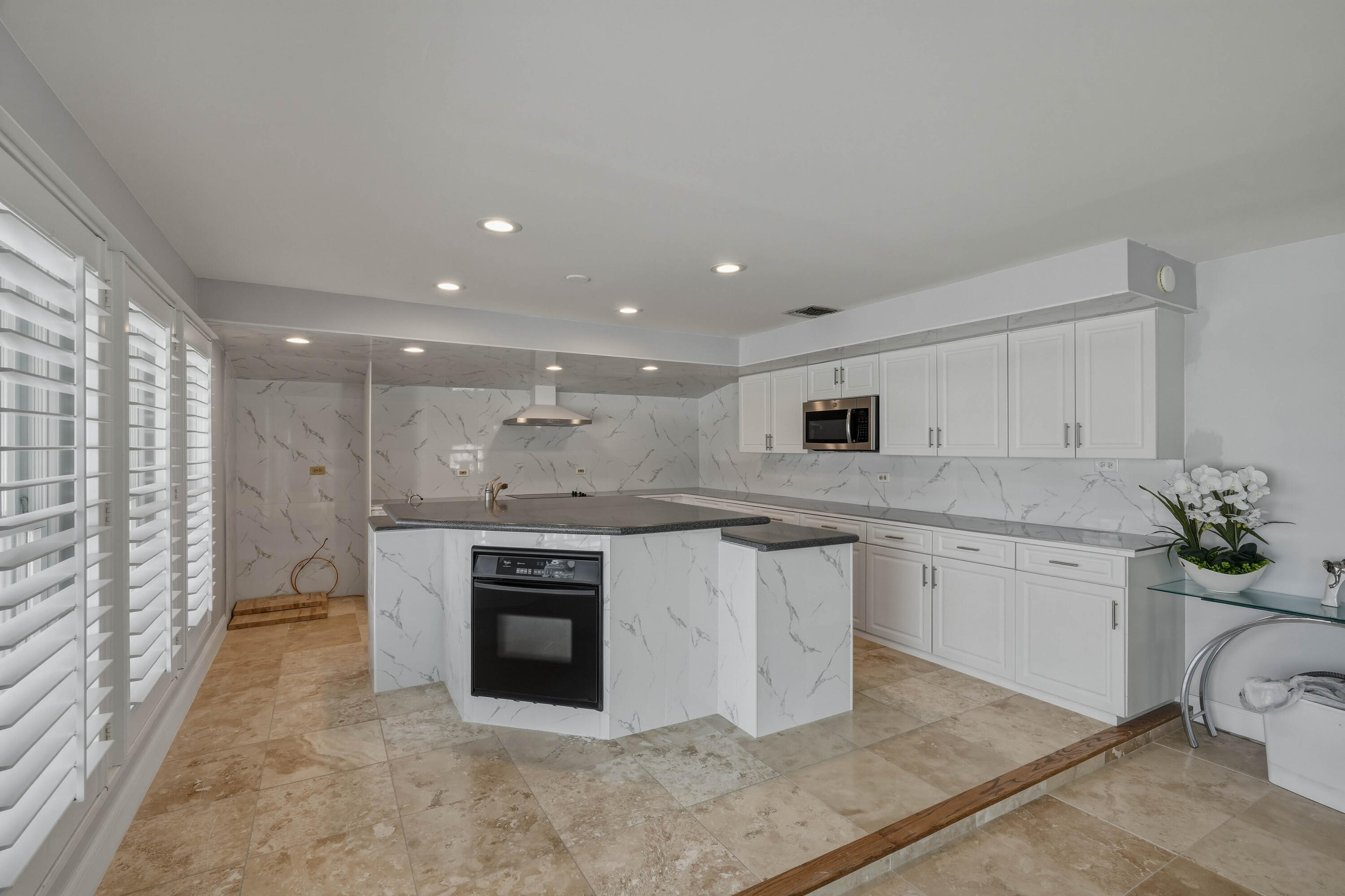 320 5th Street Key Colony Beach, FL 33051 - Photo 16 of 53 a kitchen with stainless steel appliances granite countertop a stove a sink and a microwave
