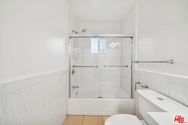 a bathroom with a bathtub and a toilet