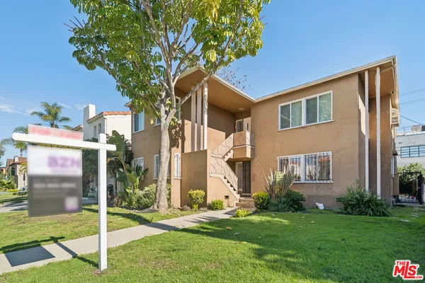 a house that has a tree in front of the house