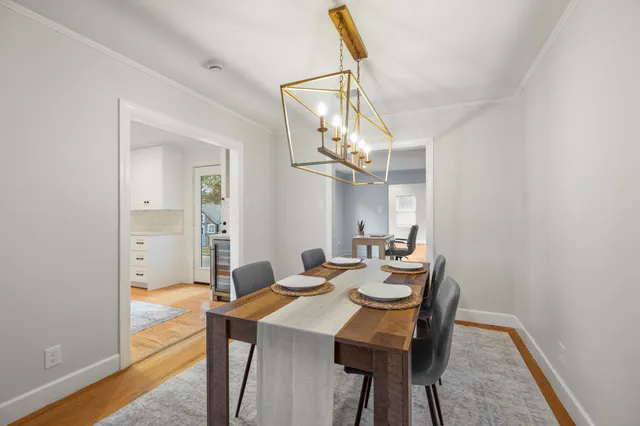 a view of a dining room with furniture and a chandelier