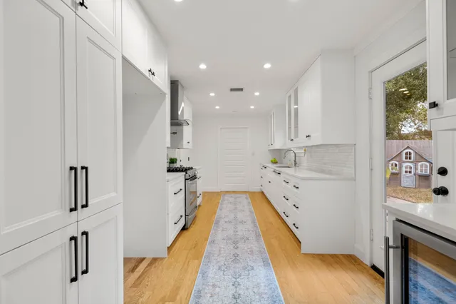 a view of a dining room with furniture a chandelier and wooden floor