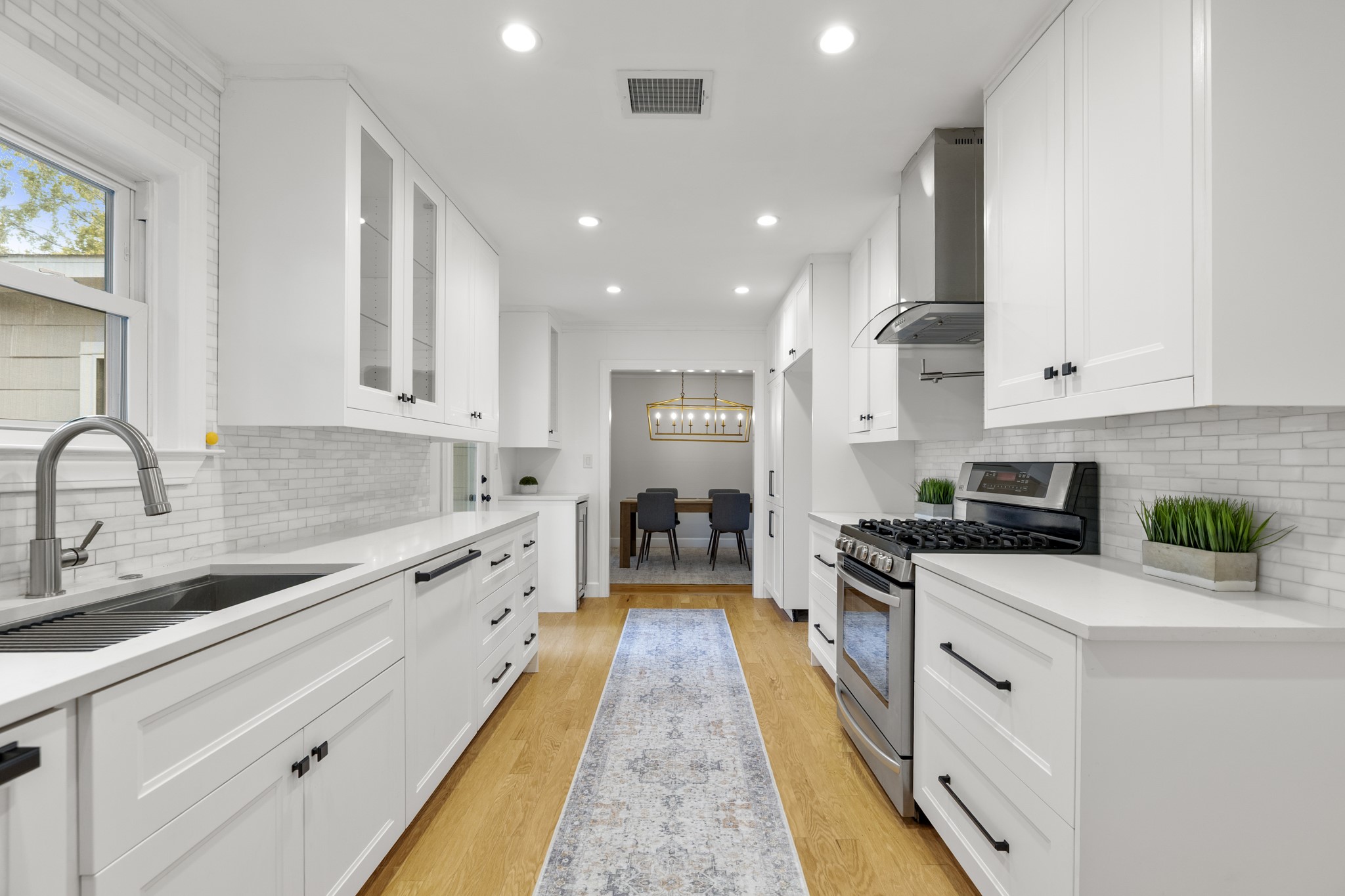 810 Nashua Street Houston, TX 77008 - Photo 22 of 35 a large kitchen with stainless steel appliances granite countertop a lot of counter space and wooden floors