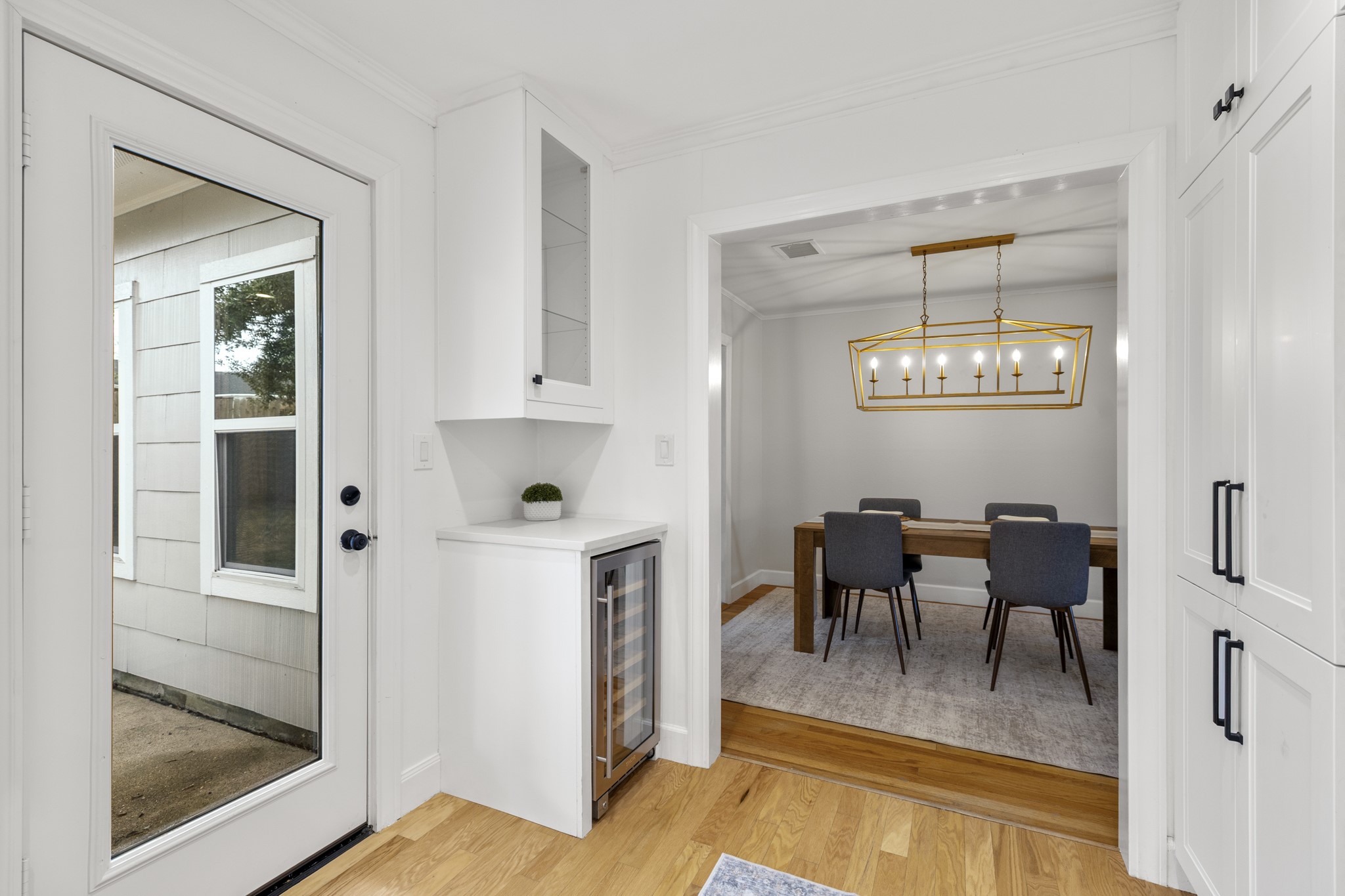 810 Nashua Street Houston, TX 77008 - Photo 23 of 35 a view of a dining room with furniture a chandelier and wooden floor