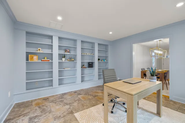 a backyard of a house with table and chairs