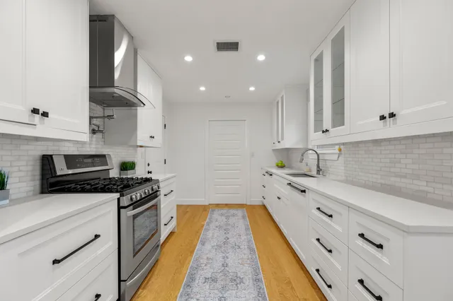 a kitchen with cabinets and appliances