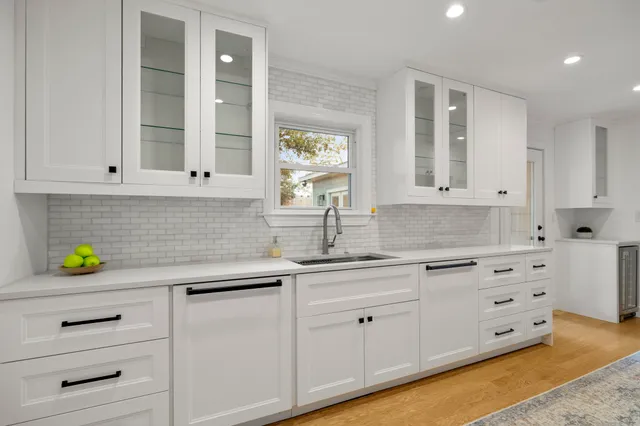 a kitchen with stainless steel appliances a stove a sink and a refrigerator