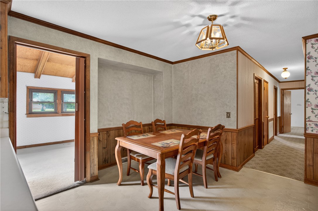 112 Holliday Lane Pendleton, SC 29670 - Photo 14 of 42 A well-lit dining area offers a cozy space for meals, accented with rich wood trim and classic paneling.